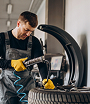 Tire technician checking pressure and alignment – Denver service